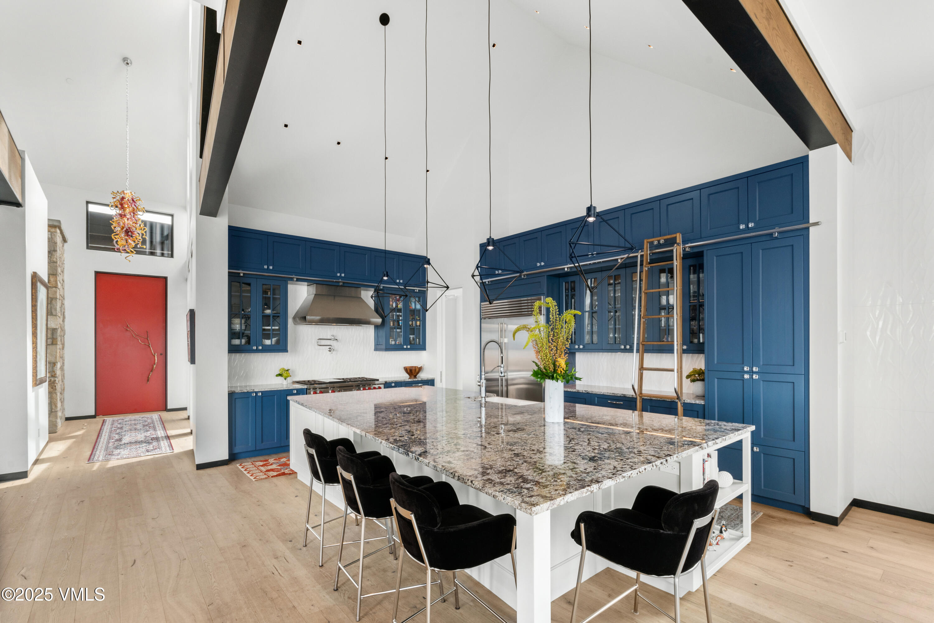 594 Winchester Trail Edwards, CO 81632 - Photo 7 of 46 a kitchen with stainless steel appliances kitchen island granite countertop a table chairs and a refrigerator