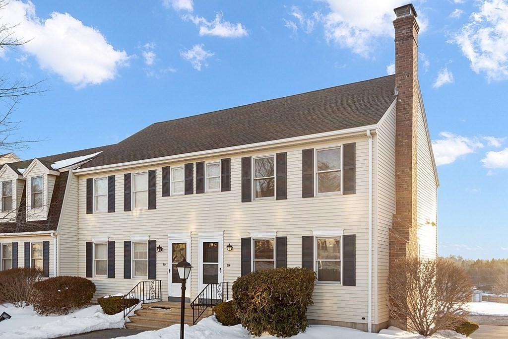 a front view of a building with a yard