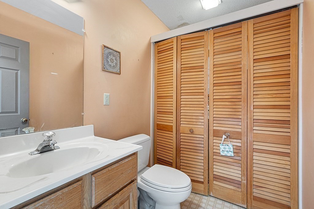 84 Century Way, Unit 84 Gardner, MA 01440 - Photo 14 of 28 a bathroom with a sink a toilet and vanity