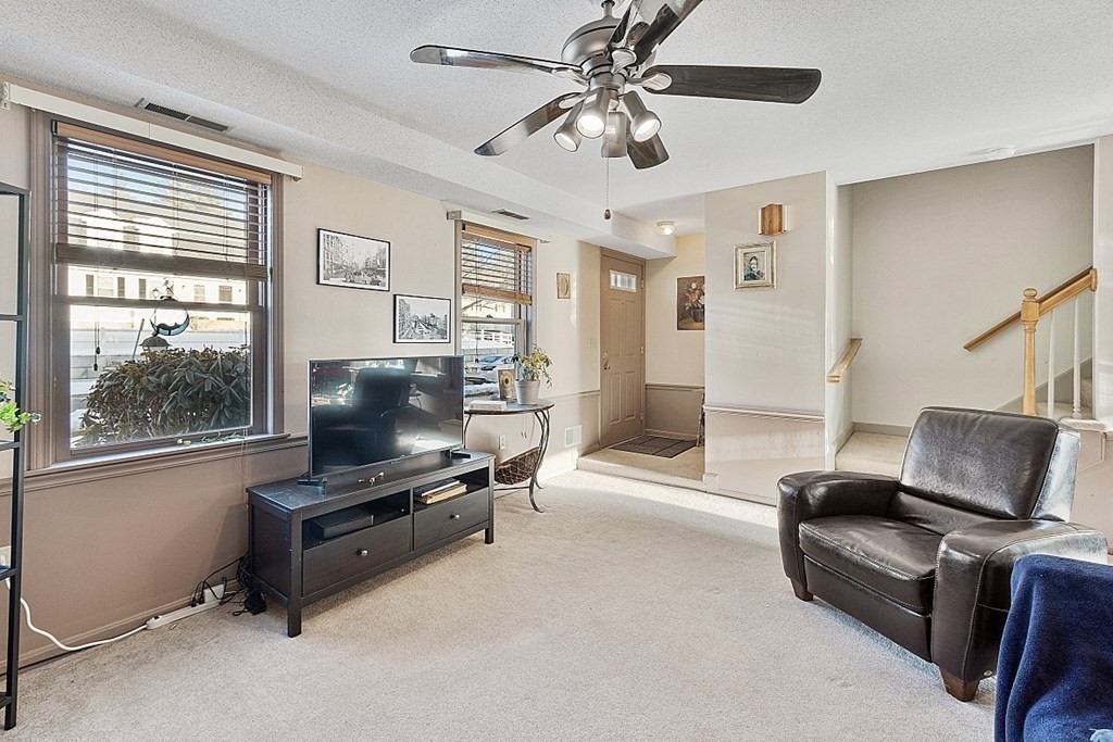 84 Century Way, Unit 84 Gardner, MA 01440 - Photo 16 of 28 a living room with furniture and a flat screen tv