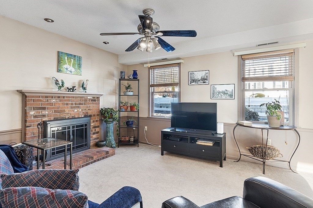 84 Century Way, Unit 84 Gardner, MA 01440 - Photo 17 of 28 a living room with furniture and a fireplace