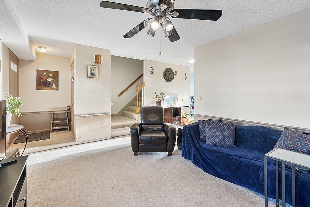 84 Century Way, Unit 84 Gardner, MA 01440 - Photo 18 of 28 a living room with furniture and a ceiling fan