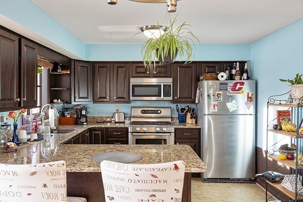84 Century Way, Unit 84 Gardner, MA 01440 - Photo 4 of 28 a kitchen with stainless steel appliances granite countertop a refrigerator a stove and a sink