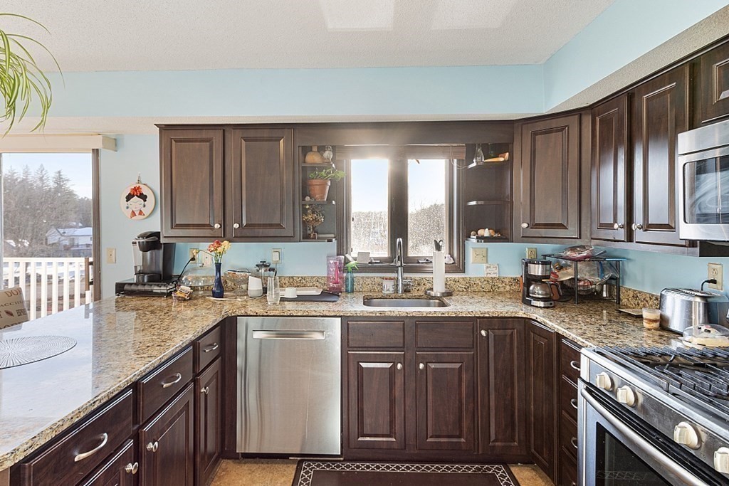 84 Century Way, Unit 84 Gardner, MA 01440 - Photo 7 of 28 a kitchen with a sink a stove and cabinets