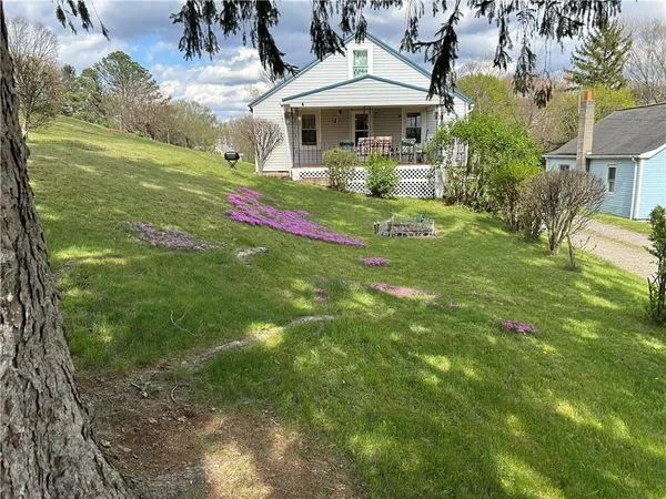 a front view of house with yard and outdoor seating