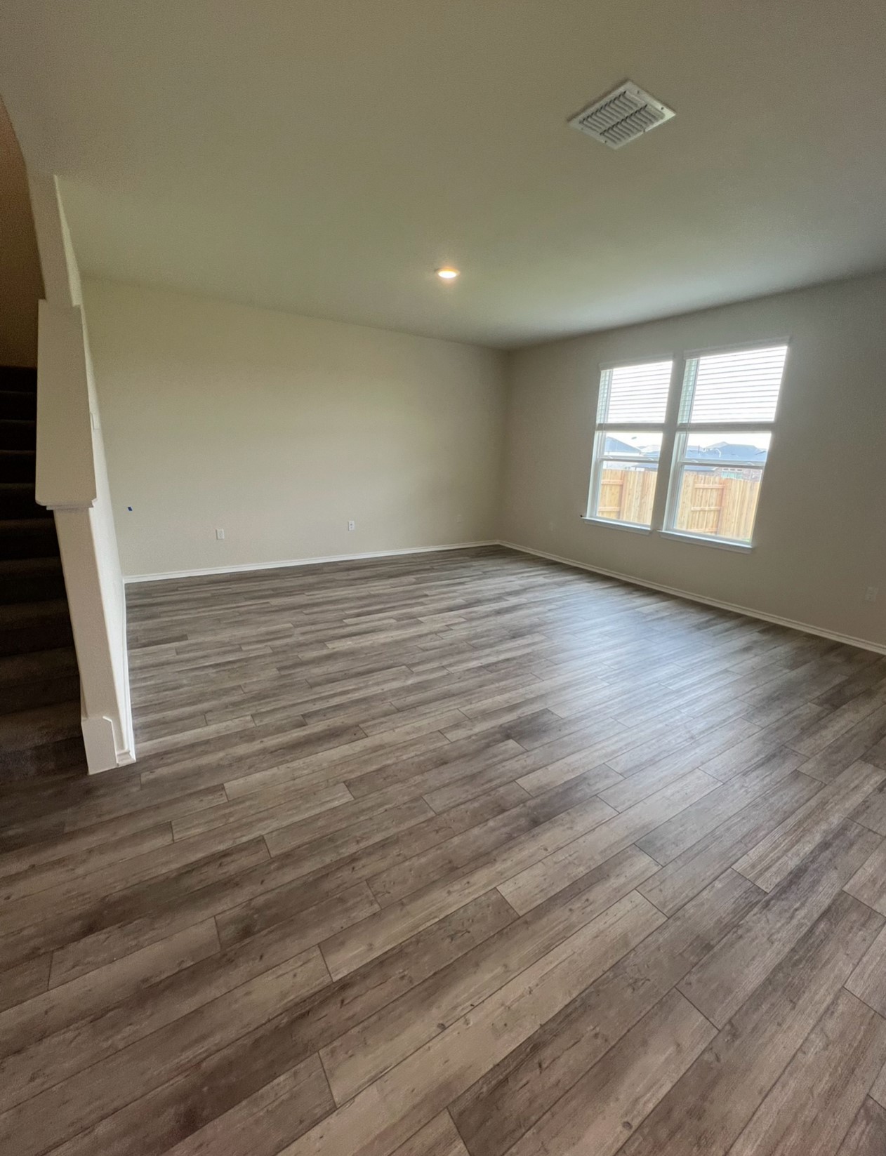 499 Tree Nut Loop Buda, TX 78610 - Photo 4 of 33 Laminate flooring extends throughout this generous living area, ready for personalization.