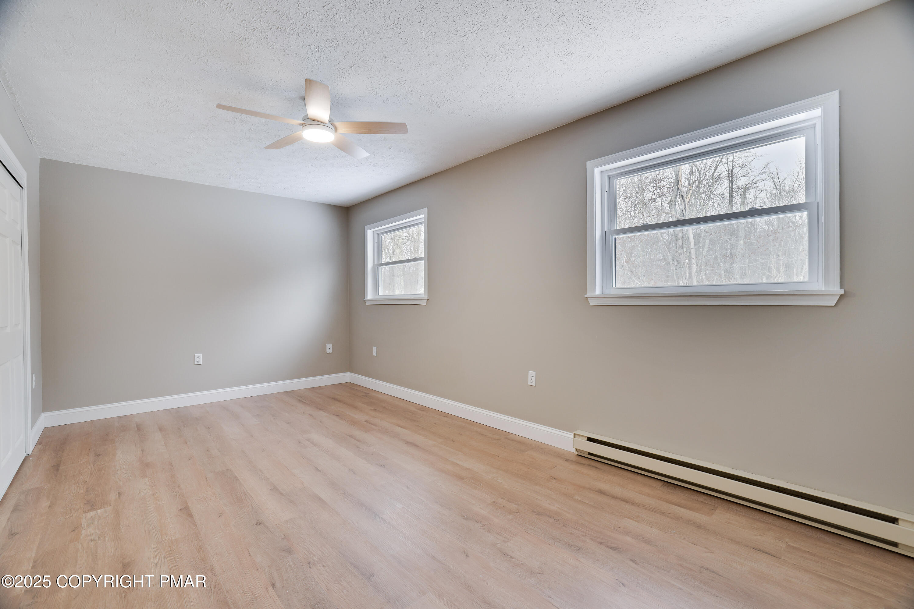 1254 Winding Way Tobyhanna, PA 18466 - Photo 19 of 46 an empty room with wooden floor chandelier fan and windows