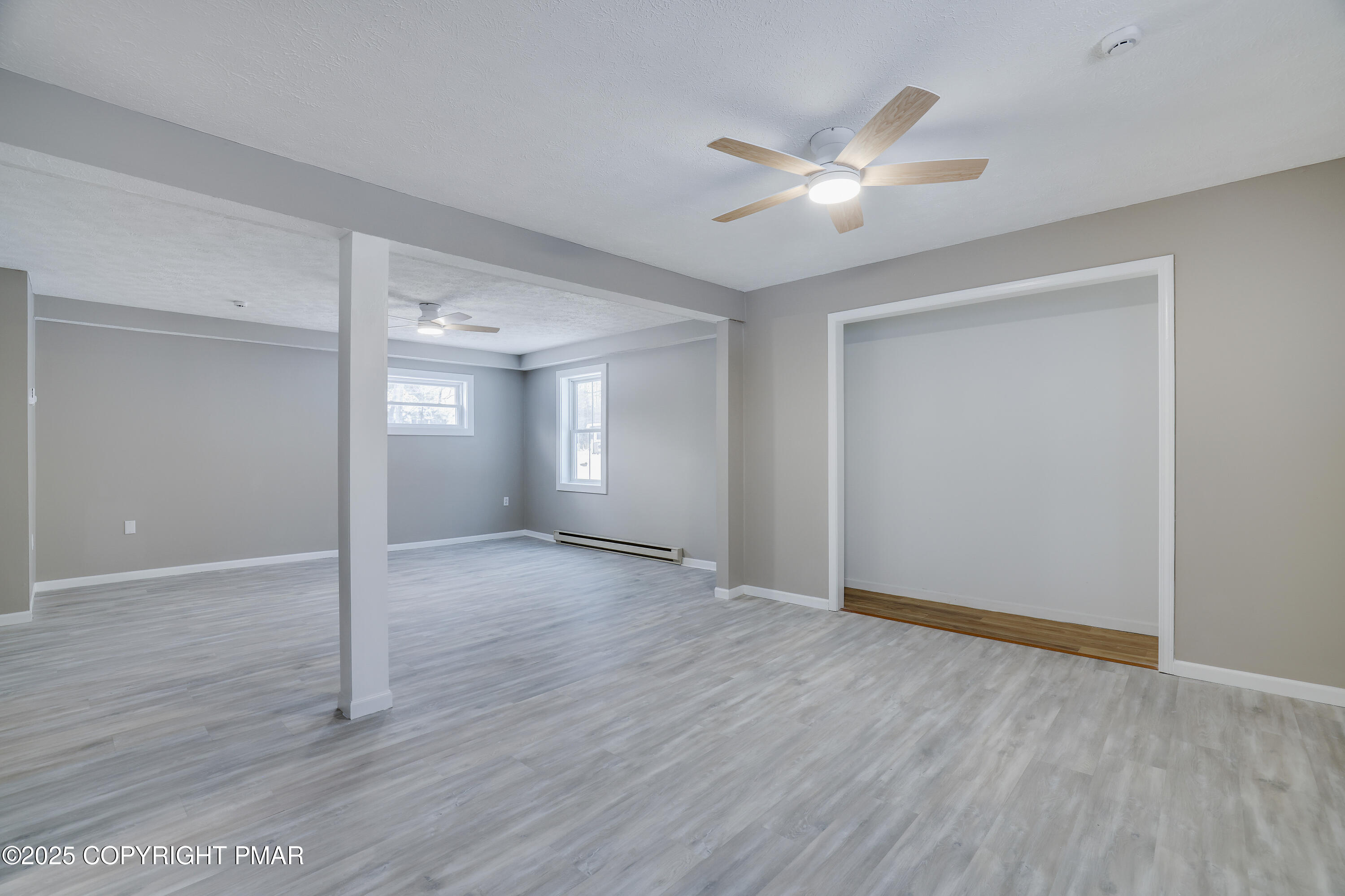 1254 Winding Way Tobyhanna, PA 18466 - Photo 30 of 46 a view of an empty room with wooden floor and a ceiling fan