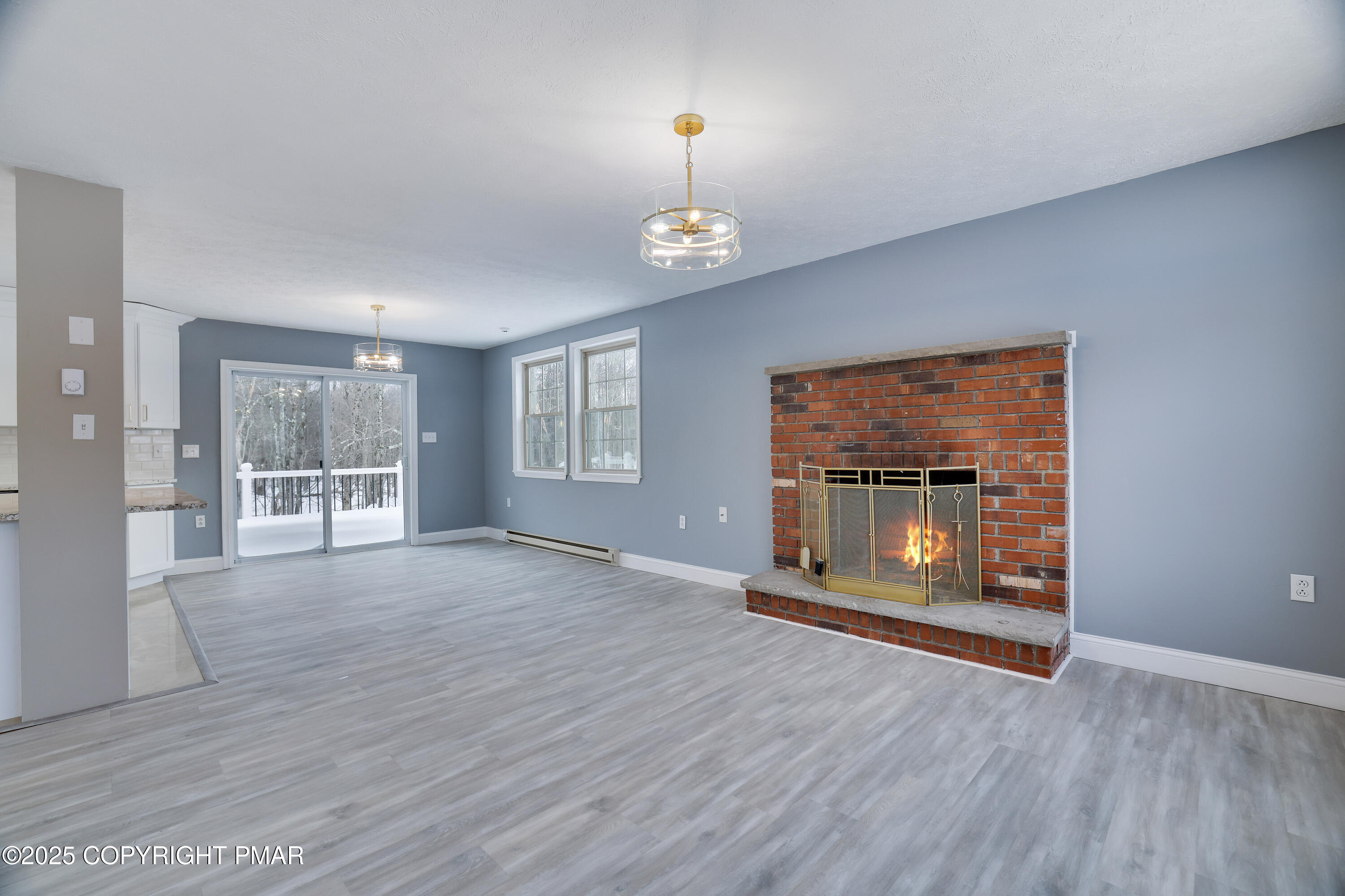 1254 Winding Way Tobyhanna, PA 18466 - Photo 10 of 46 an empty room with wooden floor fireplace and windows