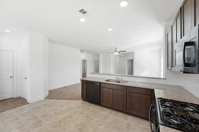 a spacious bathroom with a granite countertop sink and a mirror