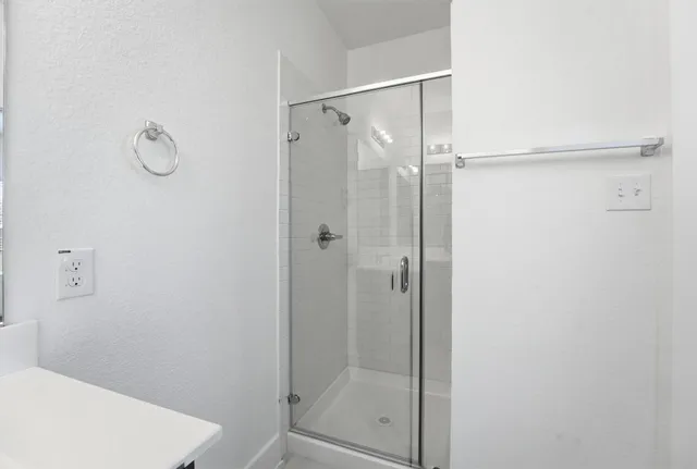 a bathroom with a glass shower door