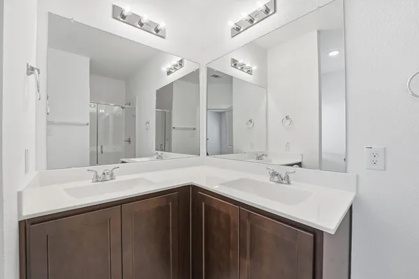 a bathroom with a sink double vanity and a mirror