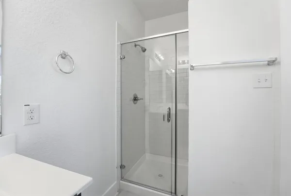 a bathroom with a glass shower door