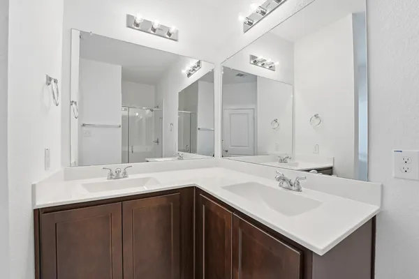a bathroom with a sink vanity and a mirror