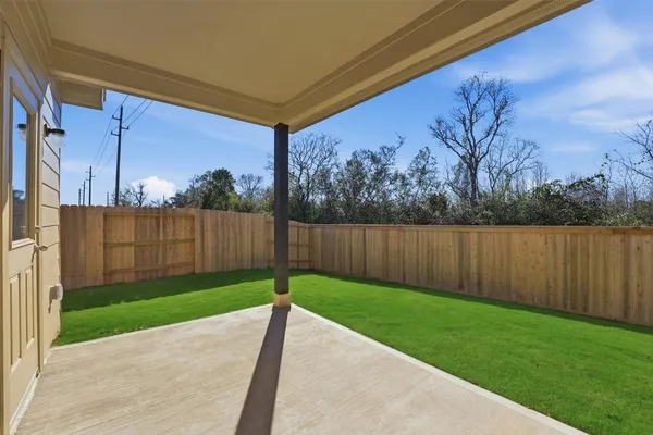 a view of a backyard with wooden fence