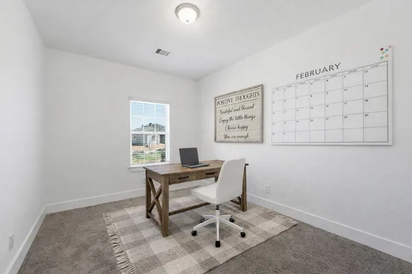 a workspace with furniture and a window