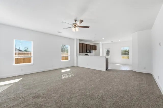 a view of a big room with windows and fireplace