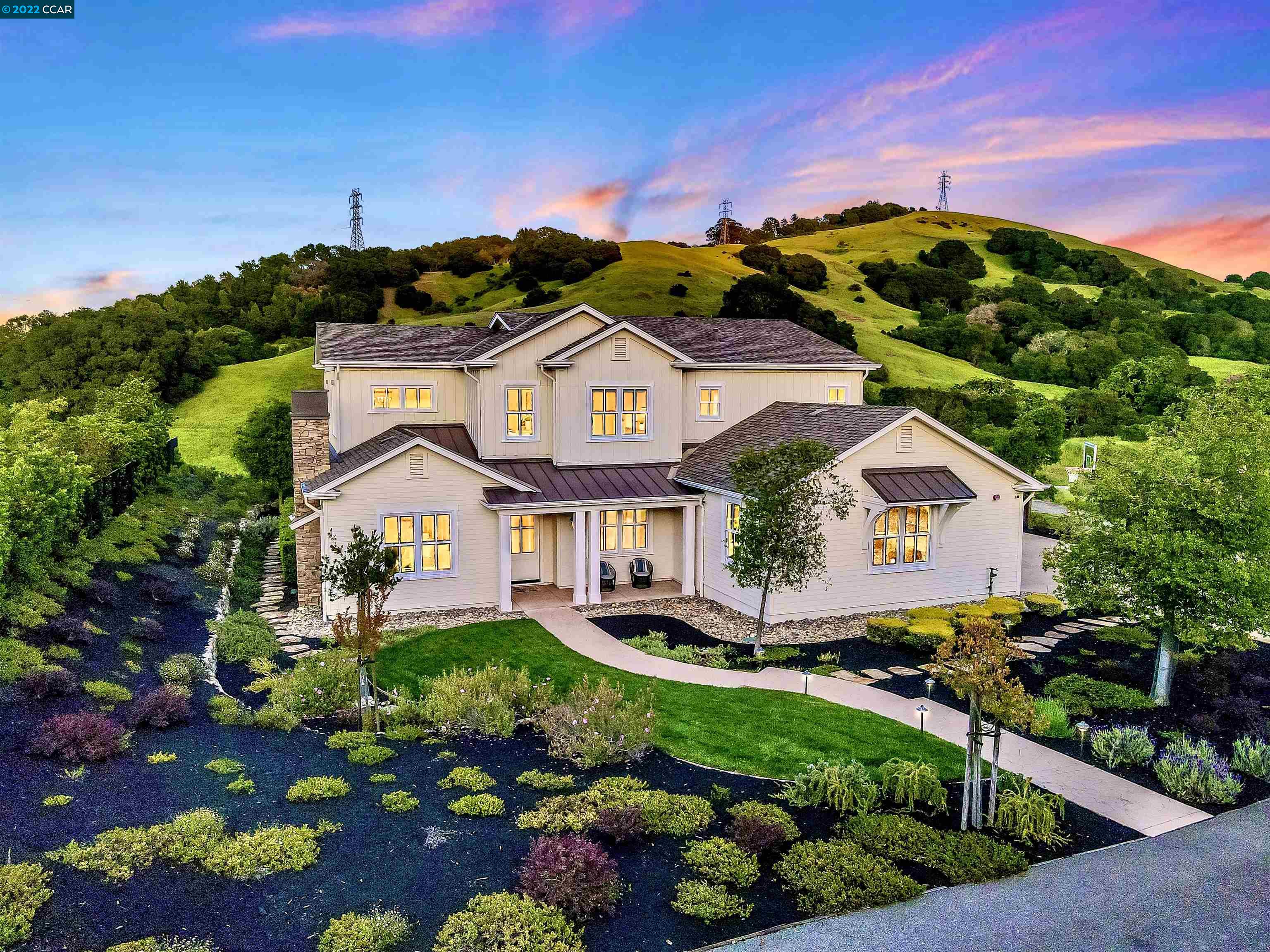 a front view of a house with a garden