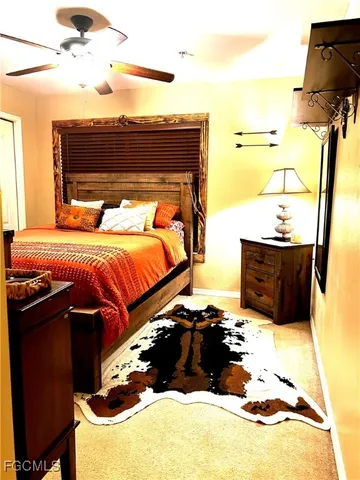 a bedroom with a bed and painting on the wall