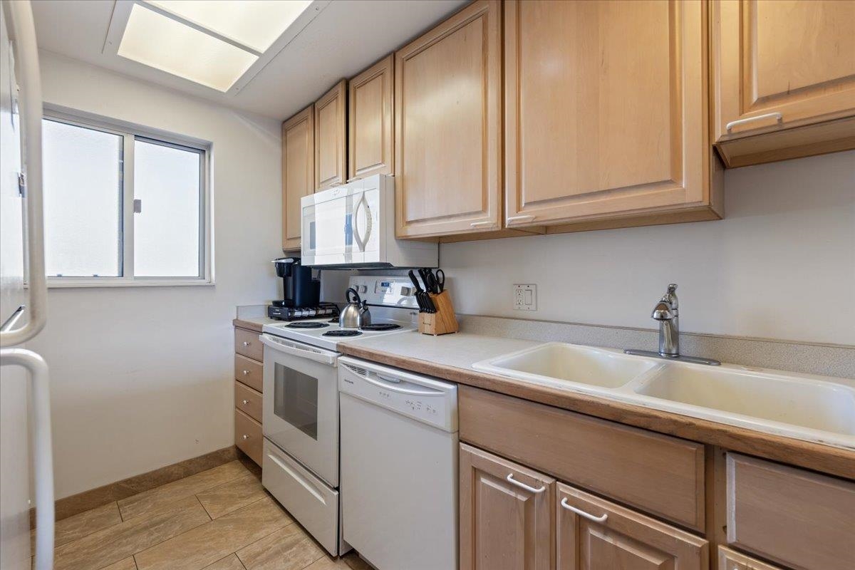 760 South Kihei Road, Unit 422 Kihei, HI 96753 - Photo 21 of 34 a kitchen with stainless steel appliances granite countertop a sink a stove and cabinets