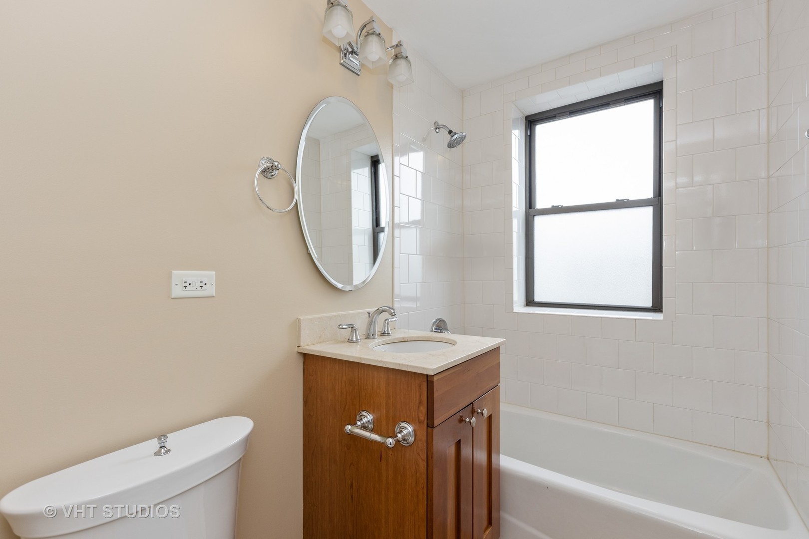 4144 North Sheridan Road, Unit 609 Chicago, IL 60613 - Photo 11 of 17 a bathroom with a sink toilet and shower with window