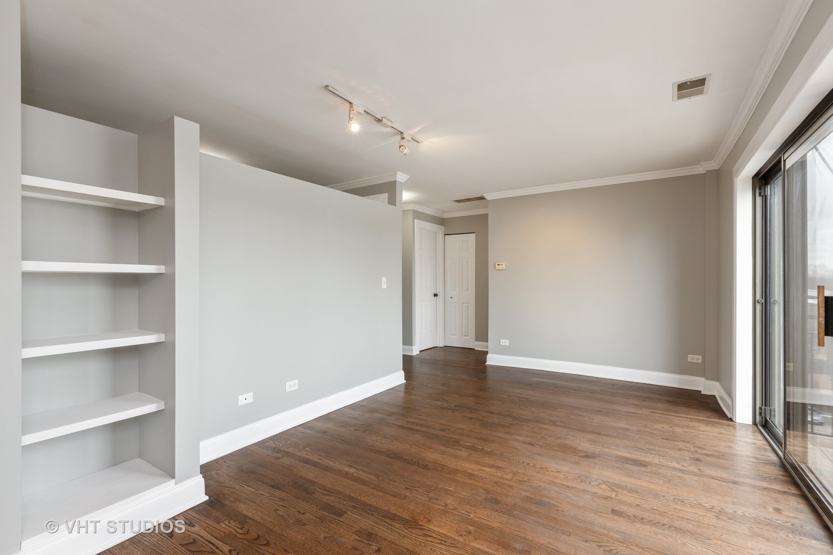 4144 North Sheridan Road, Unit 609 Chicago, IL 60613 - Photo 7 of 17 a view of an empty room with a window and wooden floor