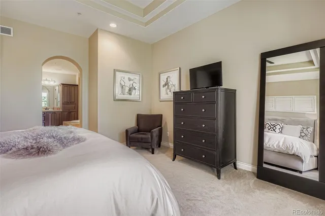 a bedroom with a bed and a television