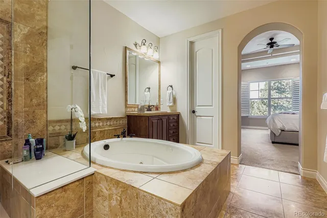 a view of bathroom with a tub and mirror