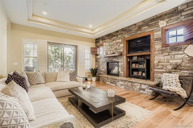 a living room with furniture large window and fireplace