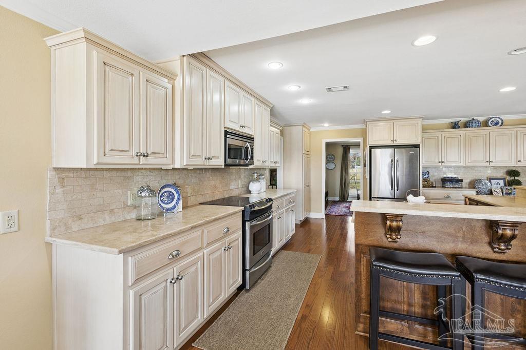 5160 Max Lane Jay, FL 32565 - Photo 14 of 54 a kitchen with stainless steel appliances granite countertop a stove top oven a sink and dishwasher a refrigerator with wooden floor