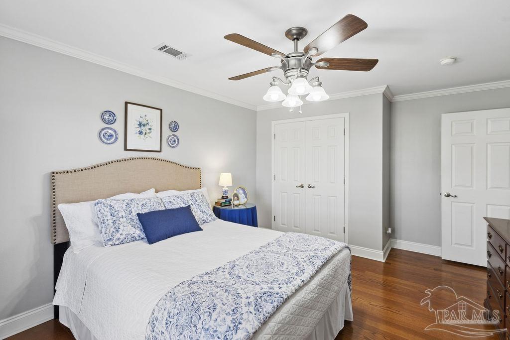5160 Max Lane Jay, FL 32565 - Photo 32 of 54 a bedroom with a large bed and a chandelier