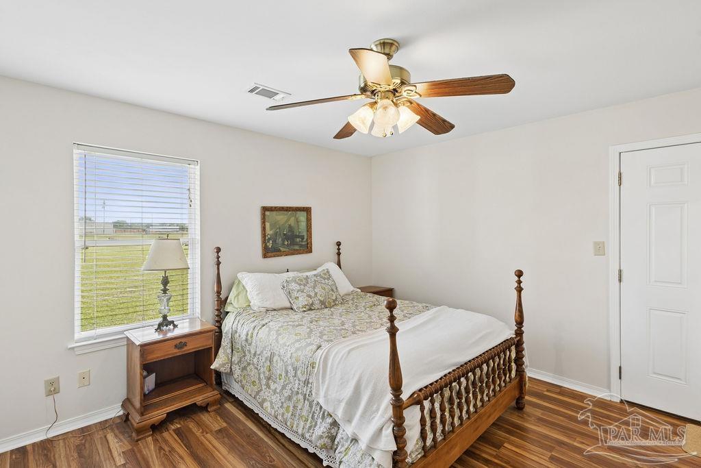 5160 Max Lane Jay, FL 32565 - Photo 37 of 54 a bedroom with a bed and wooden floor