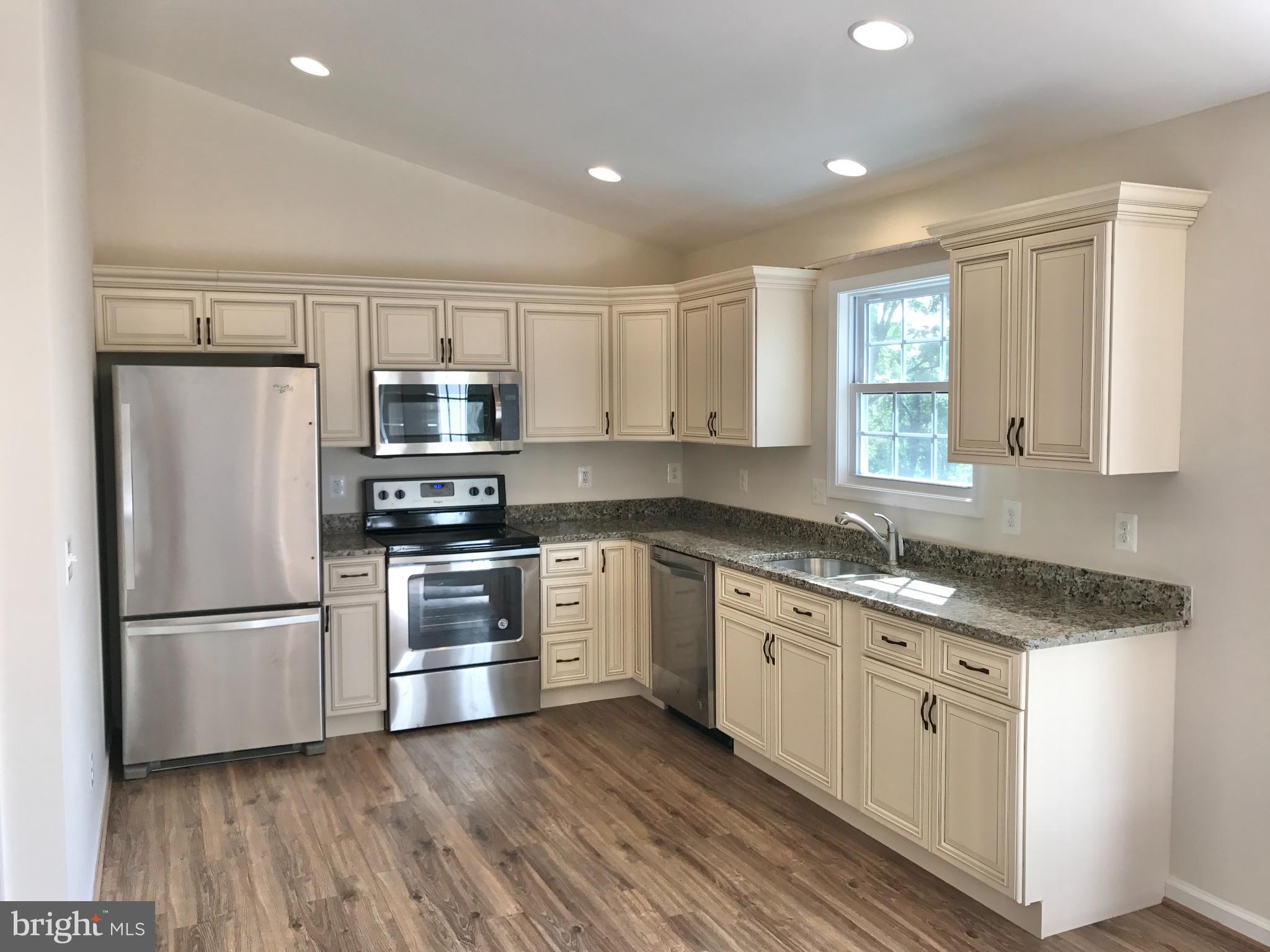 198 Heim-Jones Road Linden, VA 22642 - Photo 11 of 38 a kitchen with granite countertop white cabinets and stainless steel appliances