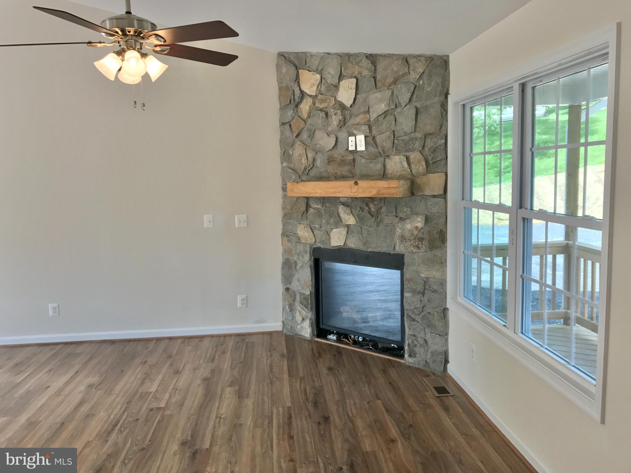 198 Heim-Jones Road Linden, VA 22642 - Photo 26 of 38 wooden floor fireplace and windows in an empty room