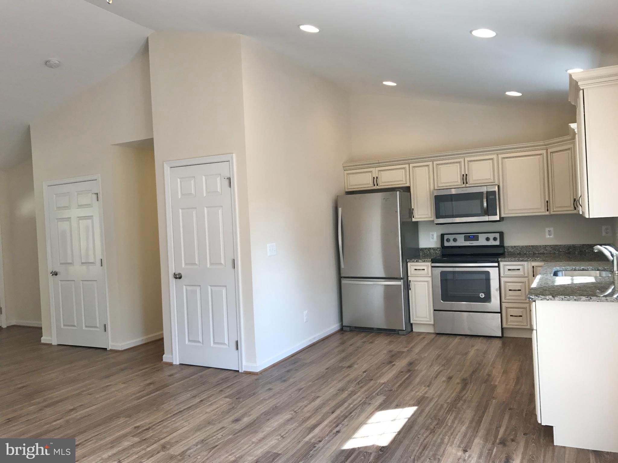 198 Heim-Jones Road Linden, VA 22642 - Photo 10 of 38 a kitchen with granite countertop a refrigerator and a stove top oven