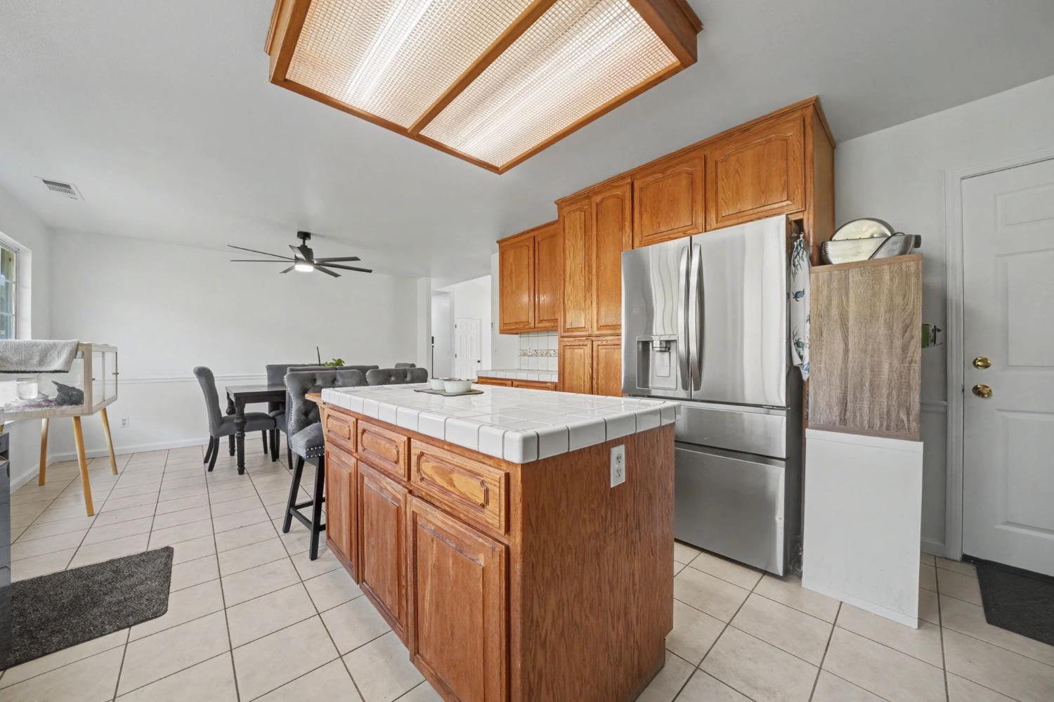7761 Jenny Lind Road Valley Springs, CA 95252 - Photo 14 of 35 a kitchen with kitchen island a counter top space and a refrigerator