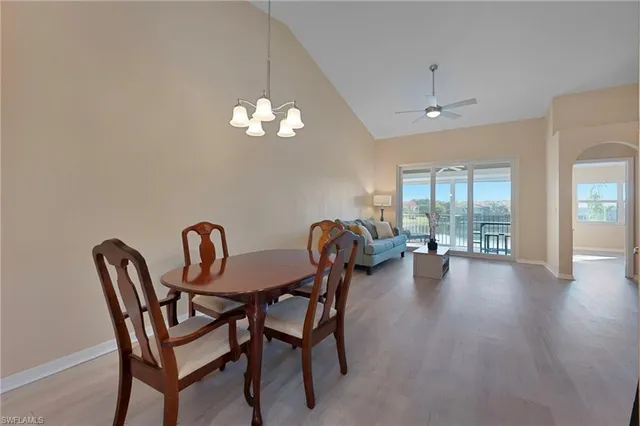 a view of a dining room with furniture wooden floor and chandelier