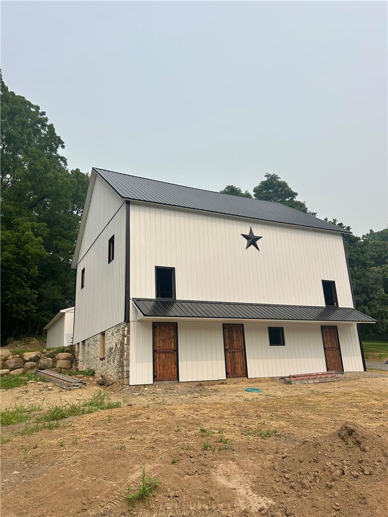 72 Allegheny Road Mount Bethel, PA 18343 - Photo 55 of 75 A newly constructed barn with crisp white siding and a bold black metal roof stands ready for purpose.