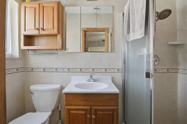 a bathroom with a toilet sink and mirror