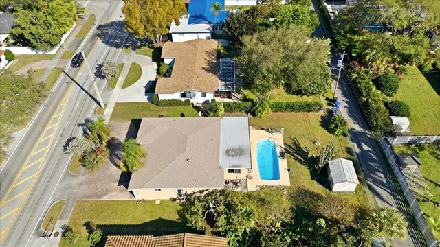 an aerial view of a house with a yard and garden