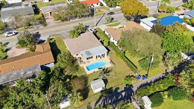 an aerial view of a house with a yard and garden