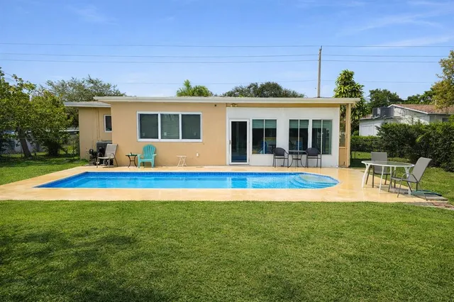 a view of house with a swimming pool