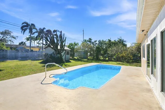 a view of a swimming pool with an outdoor space and seating area