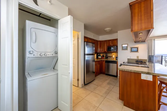 a kitchen with a refrigerator a stove top oven and a sink
