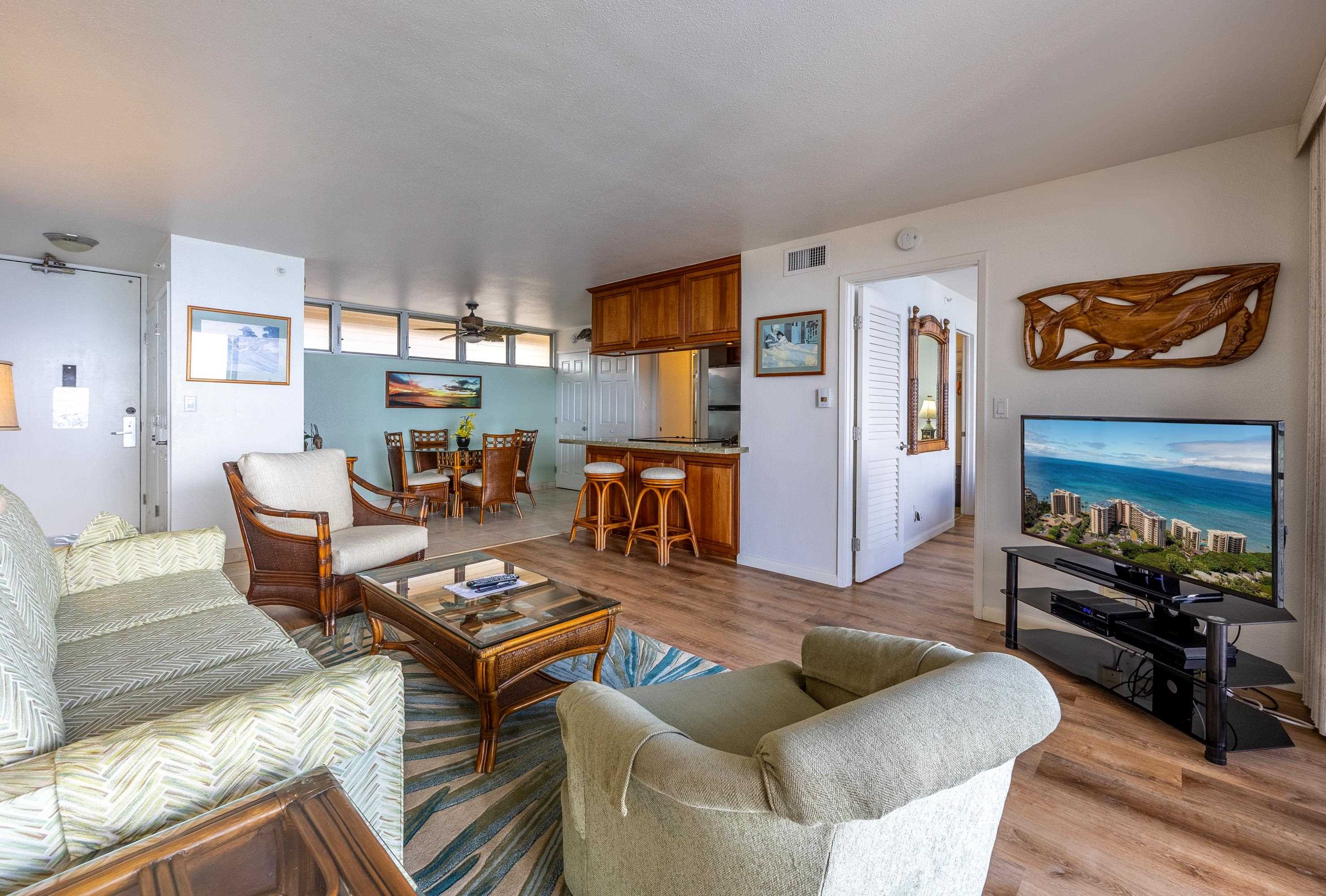 4365 Lower Honoapiilani Road, Unit 1008 Lahaina, HI 96761 - Photo 14 of 31 a living room with furniture and a flat screen tv