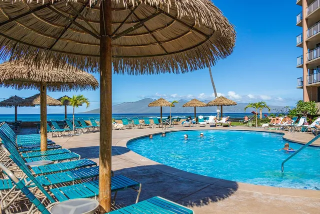 an outdoor space with swimming pool and furniture