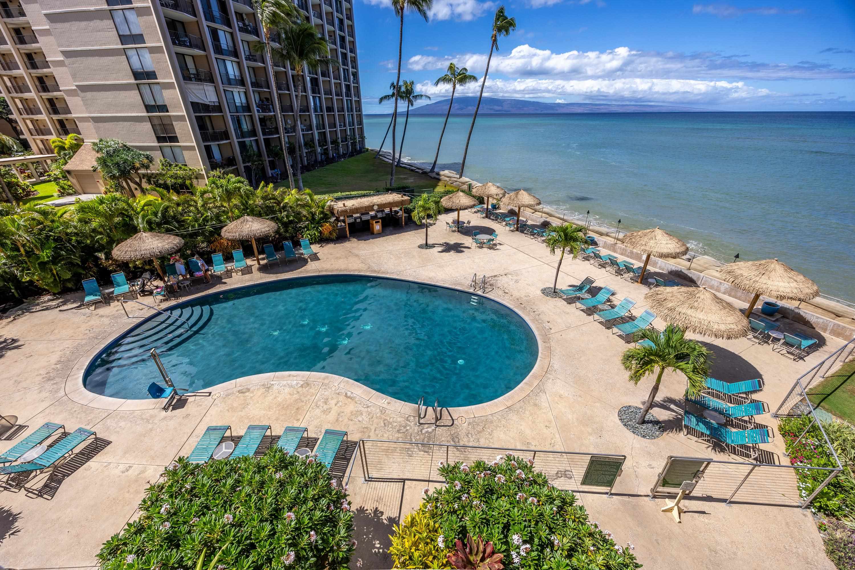 4365 Lower Honoapiilani Road, Unit 1008 Lahaina, HI 96761 - Photo 31 of 31 a view of a swimming pool with an outdoor space and seating area