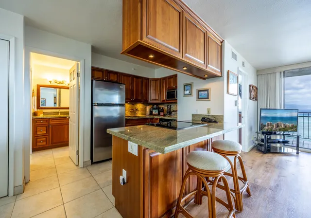 a kitchen with stainless steel appliances granite countertop a sink and a refrigerator