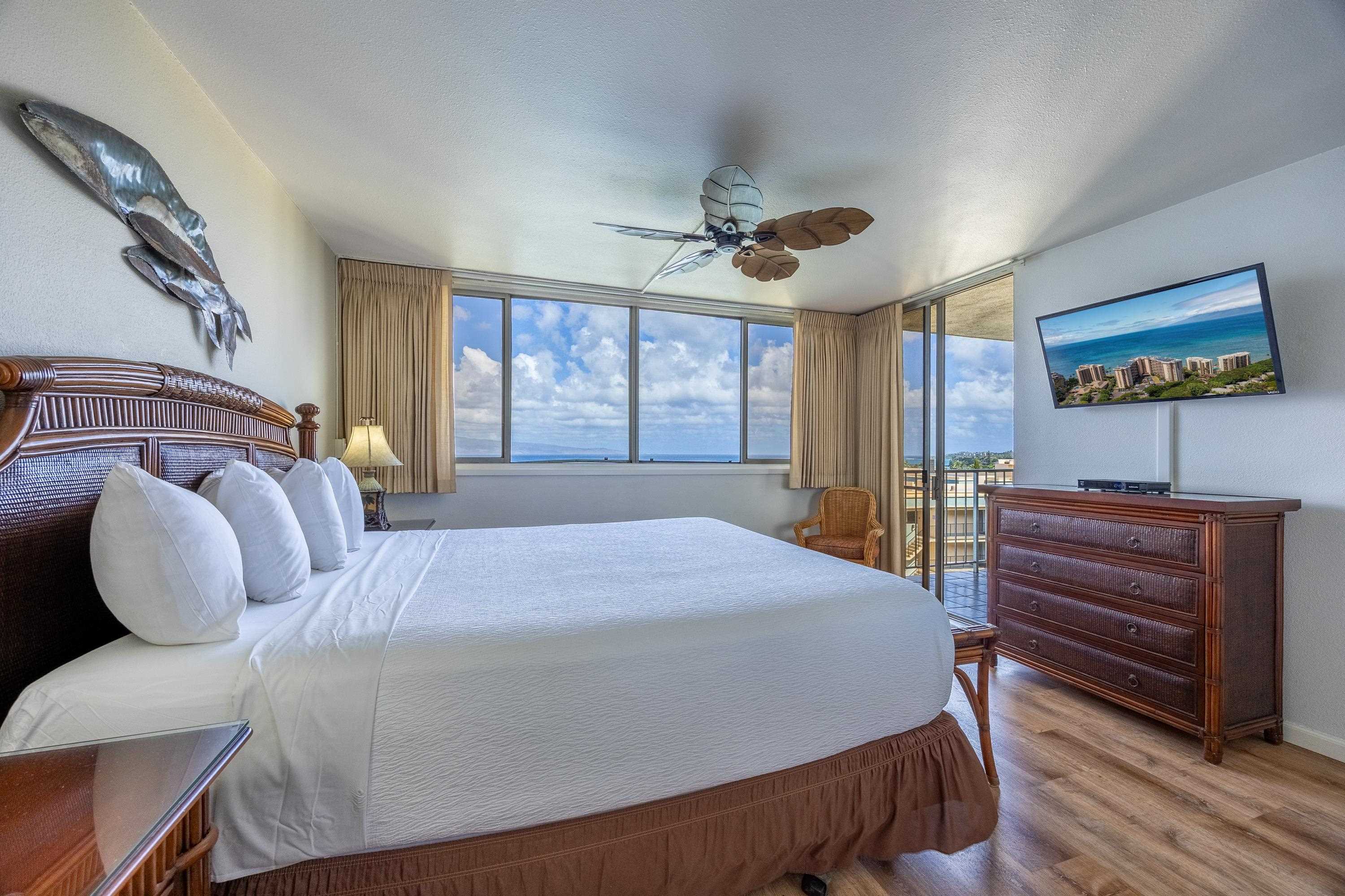 4365 Lower Honoapiilani Road, Unit 1008 Lahaina, HI 96761 - Photo 7 of 31 a bedroom with a bed and wooden floor