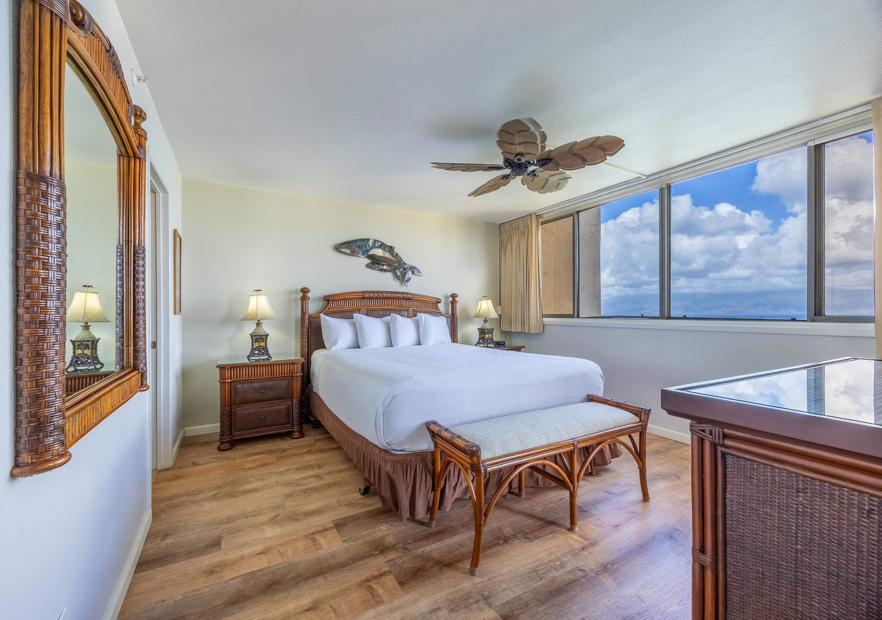 4365 Lower Honoapiilani Road, Unit 1008 Lahaina, HI 96761 - Photo 8 of 31 a bedroom with a bed and a chandelier